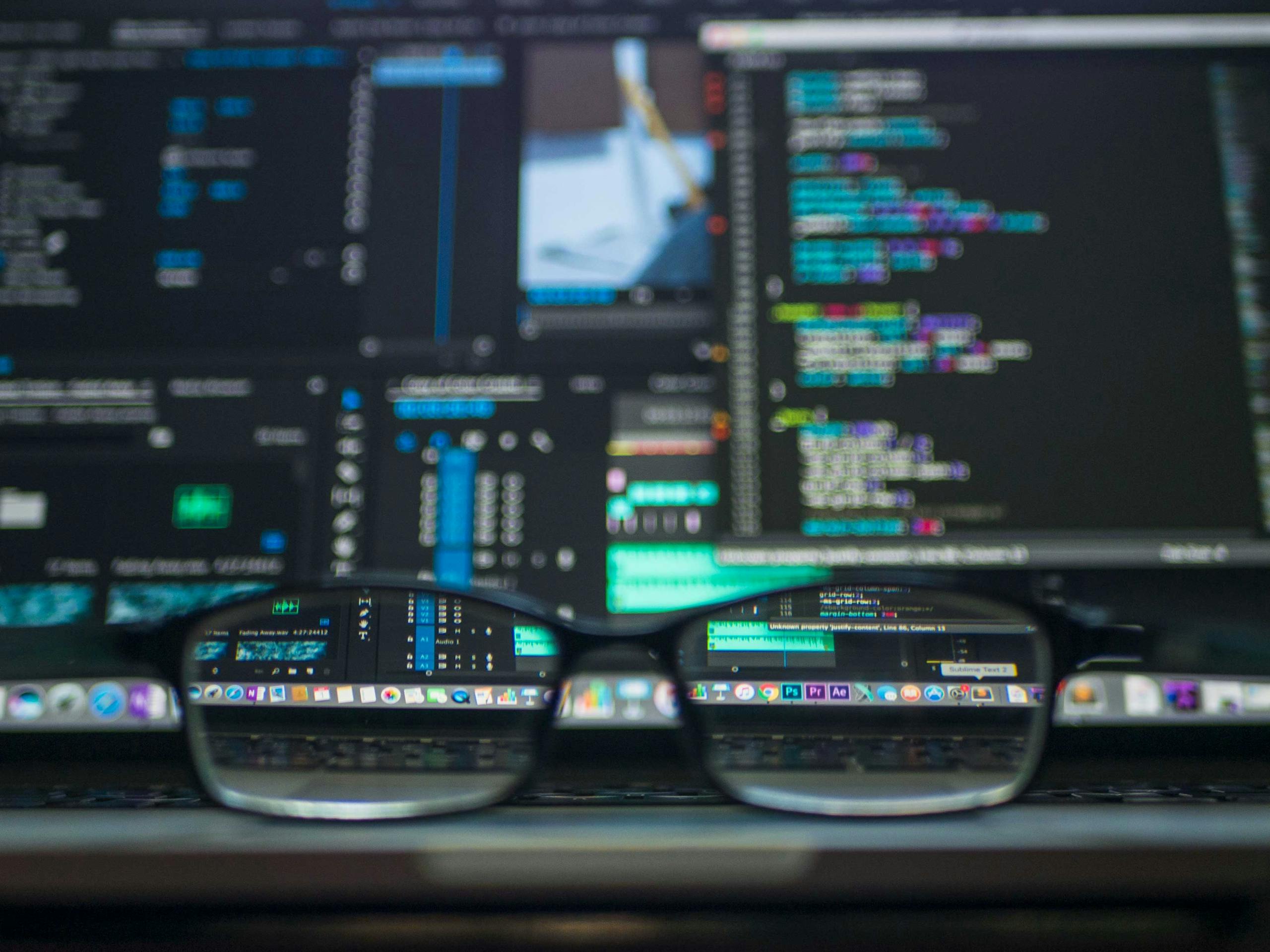 Photo by Kevin Ku Plumbum Marketing | Marketing Video for Akron Stow and Hudson Eyeglasses reflecting computer code on a monitor, ideal for technology and programming themes.